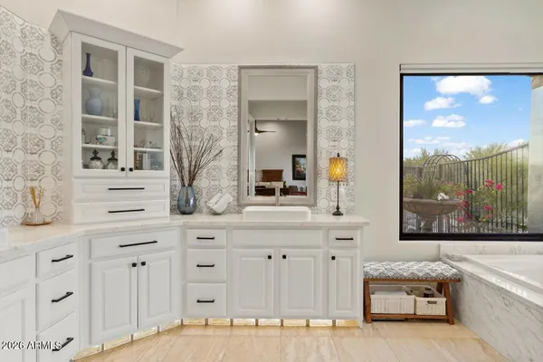 a spacious bathroom with a double vanity sink a large mirror and a bathtub