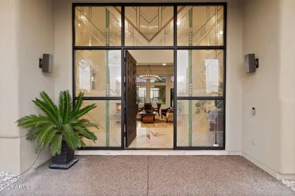 a living room with furniture a rug and a chandelier