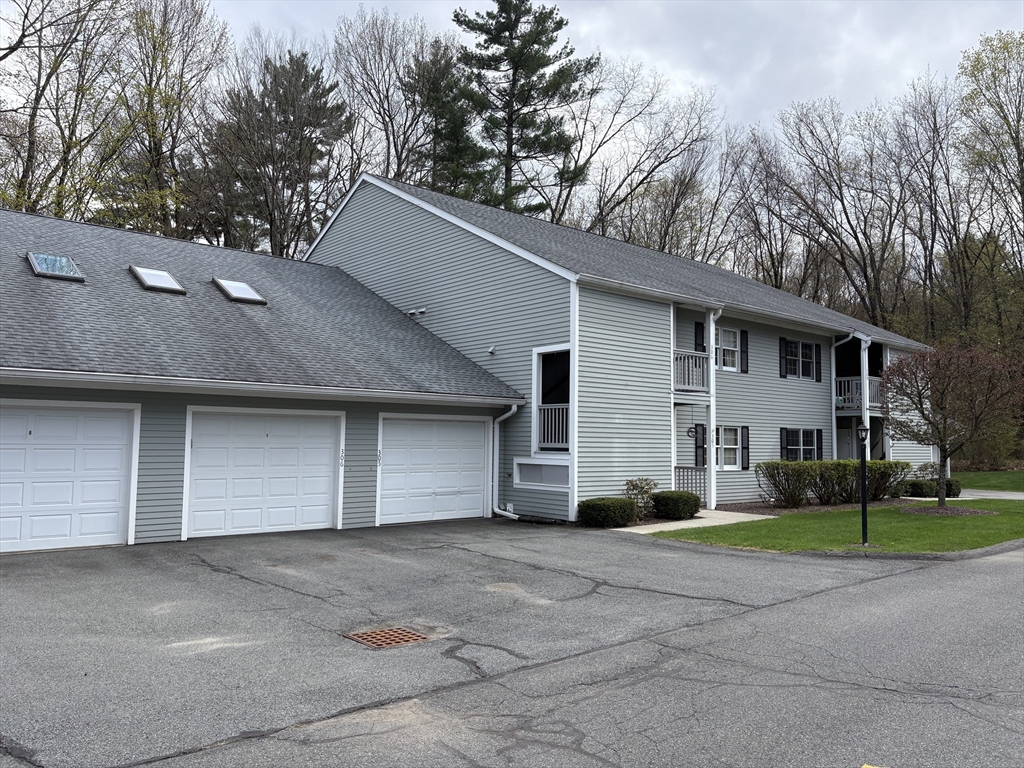 a front view of house with yard and trees around