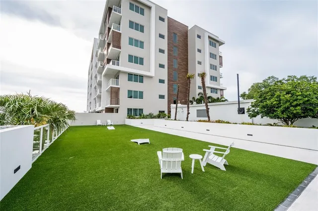 a view of swimming pool with outdoor seating and city view