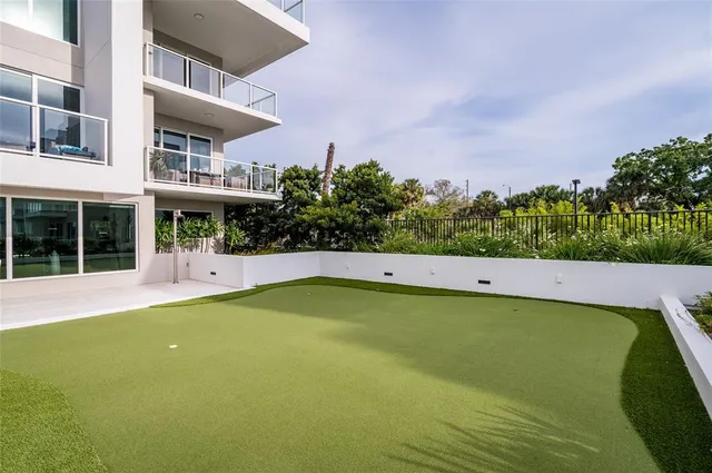 a living room with furniture a chandelier and a potted plant