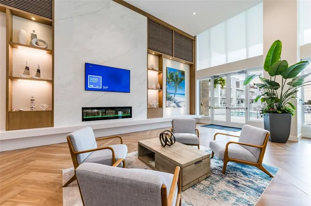 a living room with a table chairs and a flat screen tv
