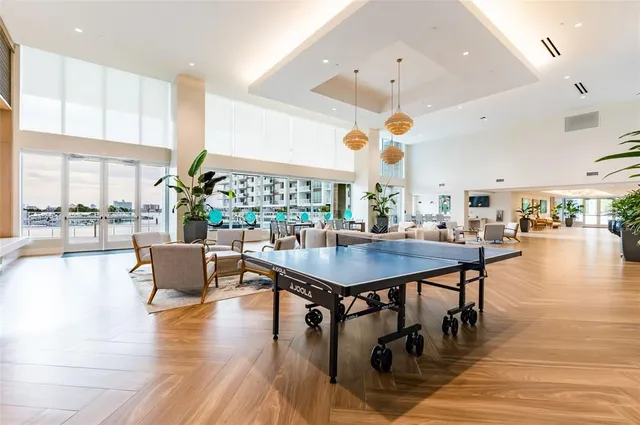 a kitchen with a sink cabinets stainless steel appliances and wooden floor