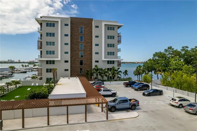 a kitchen with kitchen island a dining table chairs wooden floor and stainless steel appliances