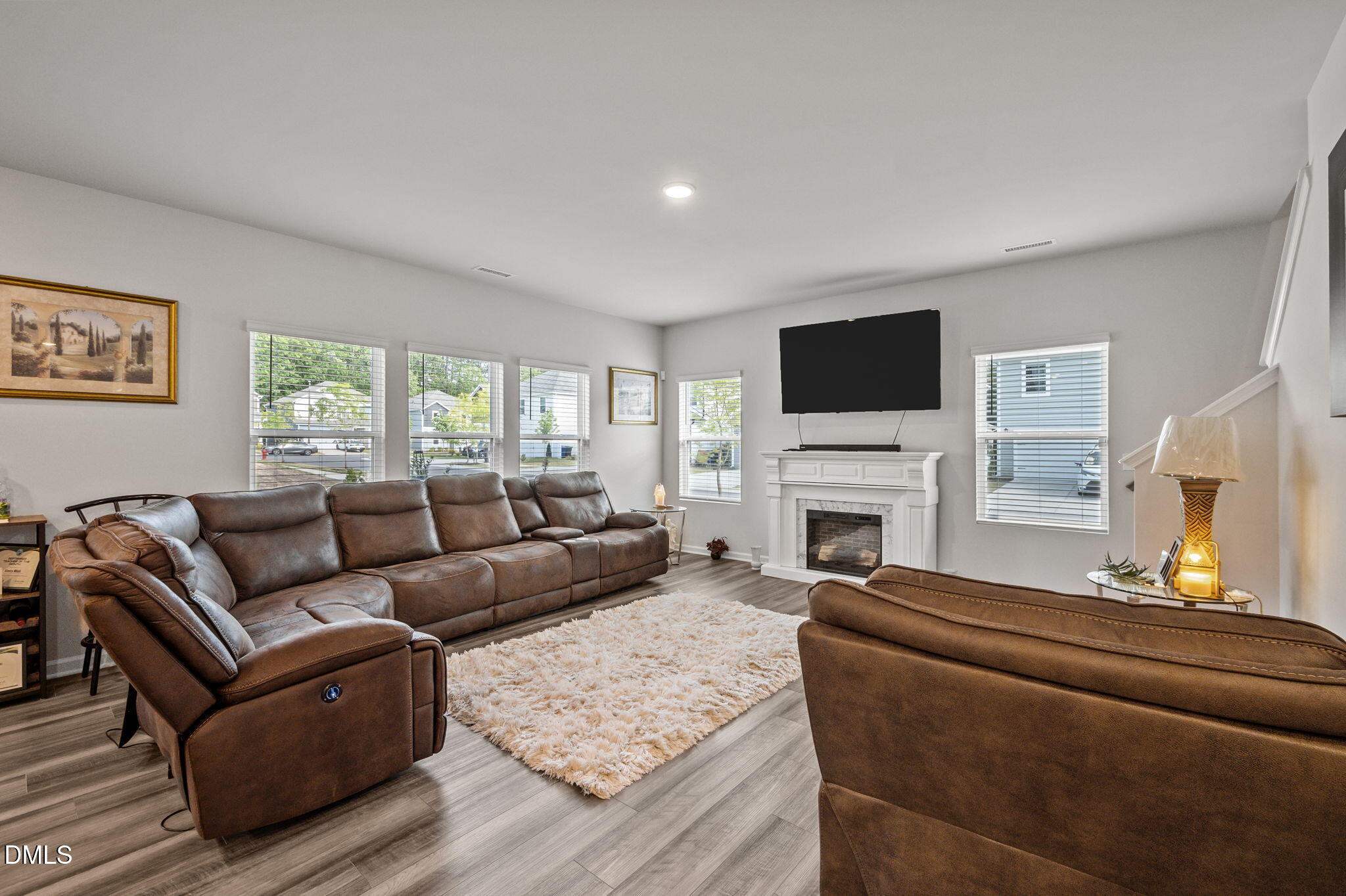 3000 Farndale Trace Durham, NC 27712 - Photo 2 of 36 a living room with furniture a fireplace and a flat screen tv