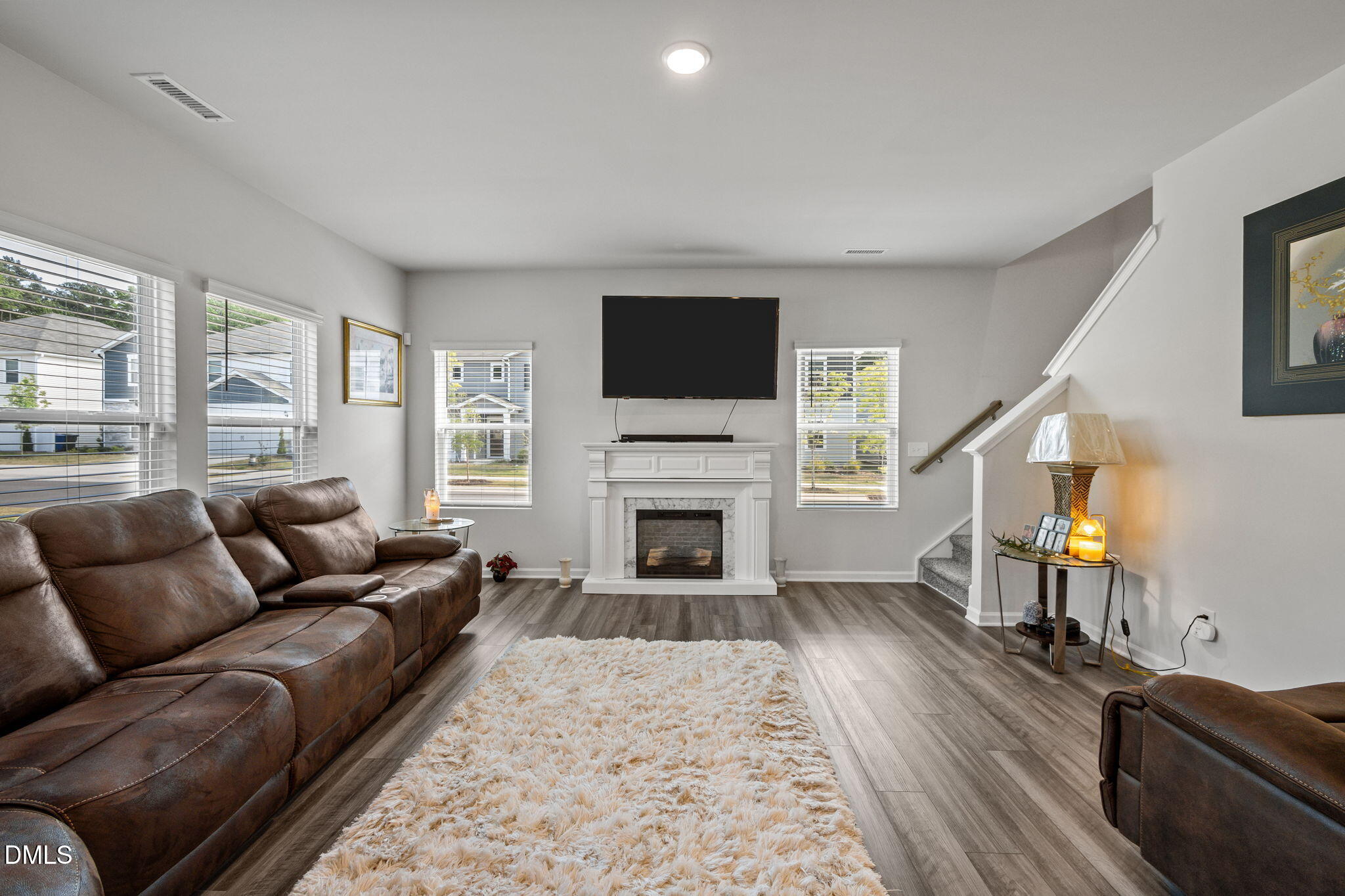 3000 Farndale Trace Durham, NC 27712 - Photo 3 of 36 a living room with furniture a flat screen tv and a fireplace
