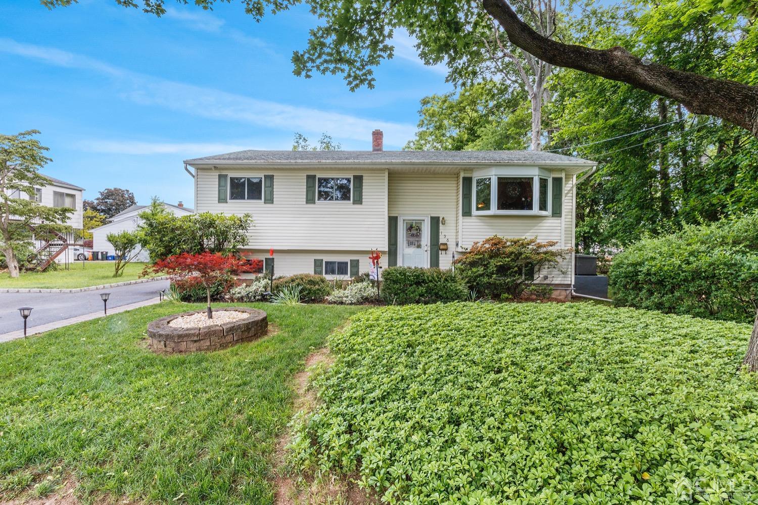 136 Lee Drive Middlesex, NJ 08846 - Photo 1 of 35 a front view of a house with a yard and garage