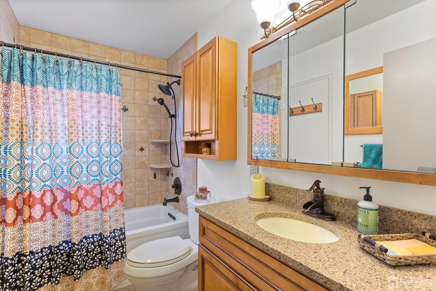 136 Lee Drive Middlesex, NJ 08846 - Photo 13 of 35 a bathroom with a granite countertop toilet sink and mirror