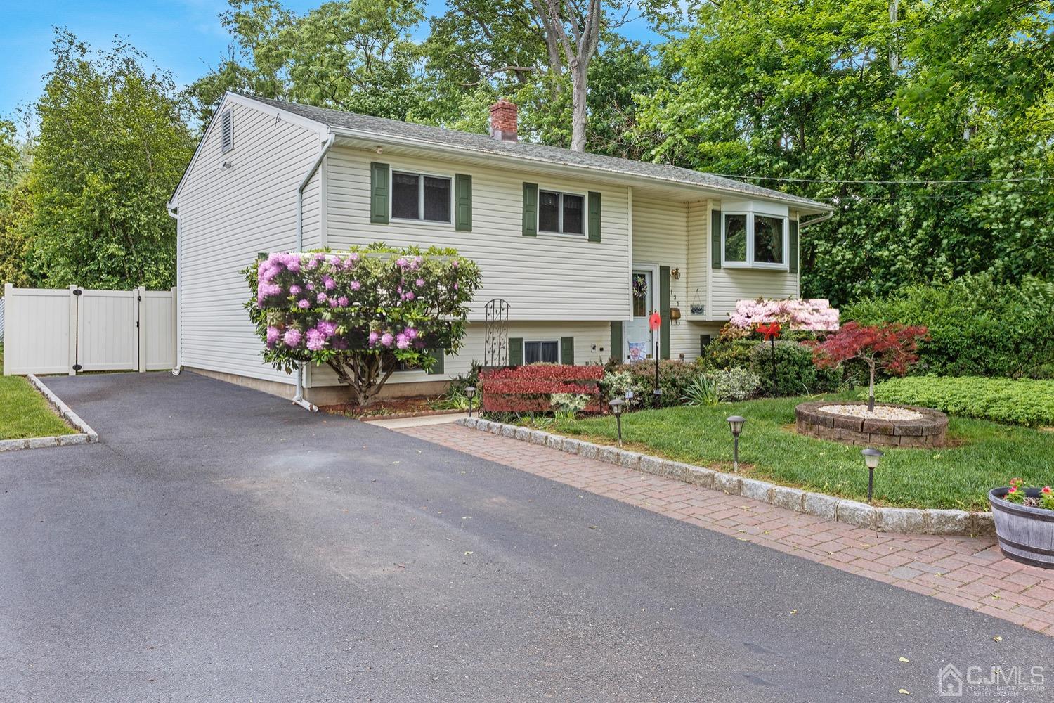136 Lee Drive Middlesex, NJ 08846 - Photo 3 of 35 a view of a house with a yard and a garden