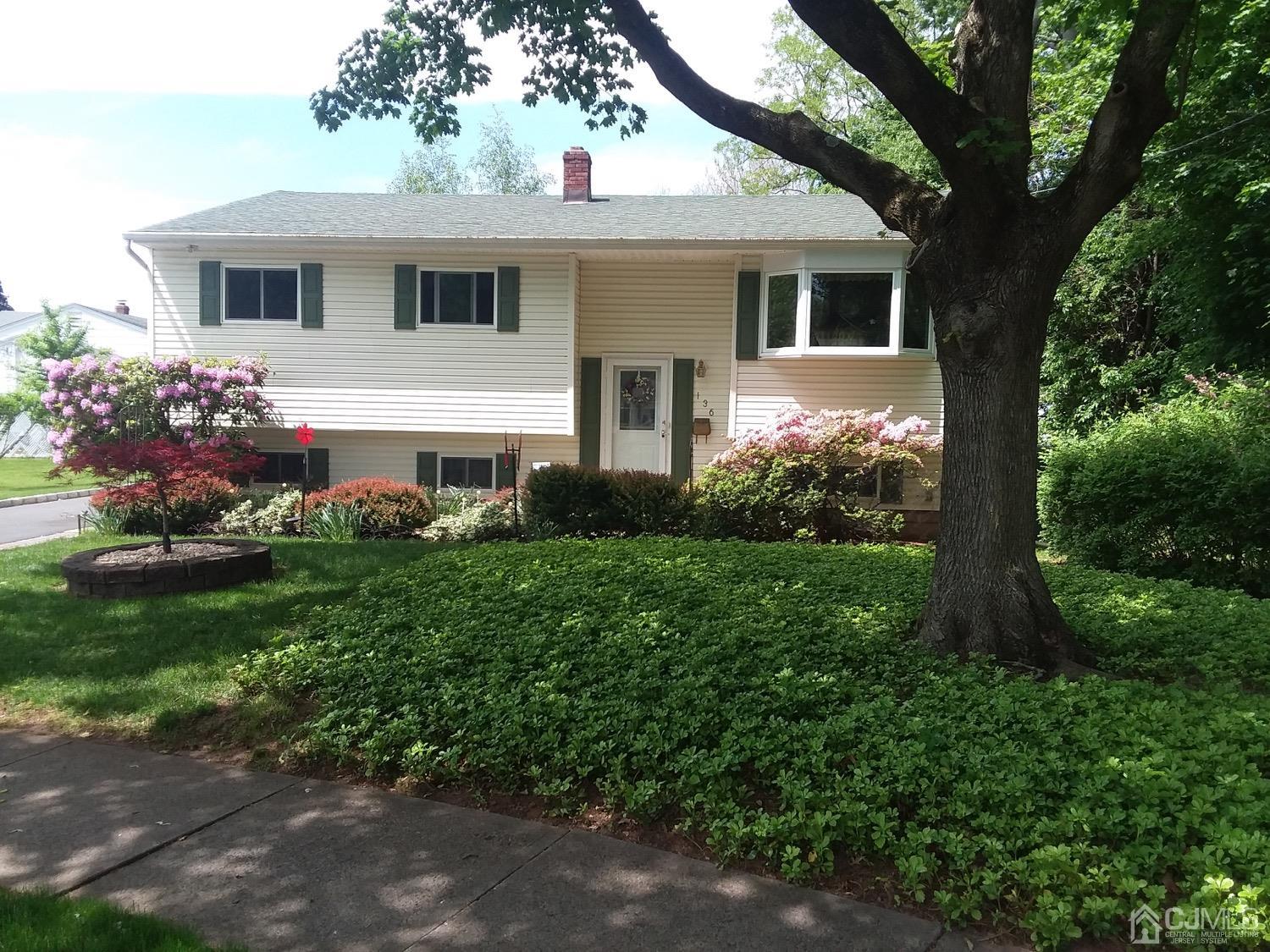 136 Lee Drive Middlesex, NJ 08846 - Photo 33 of 35 a front view of a house with garden