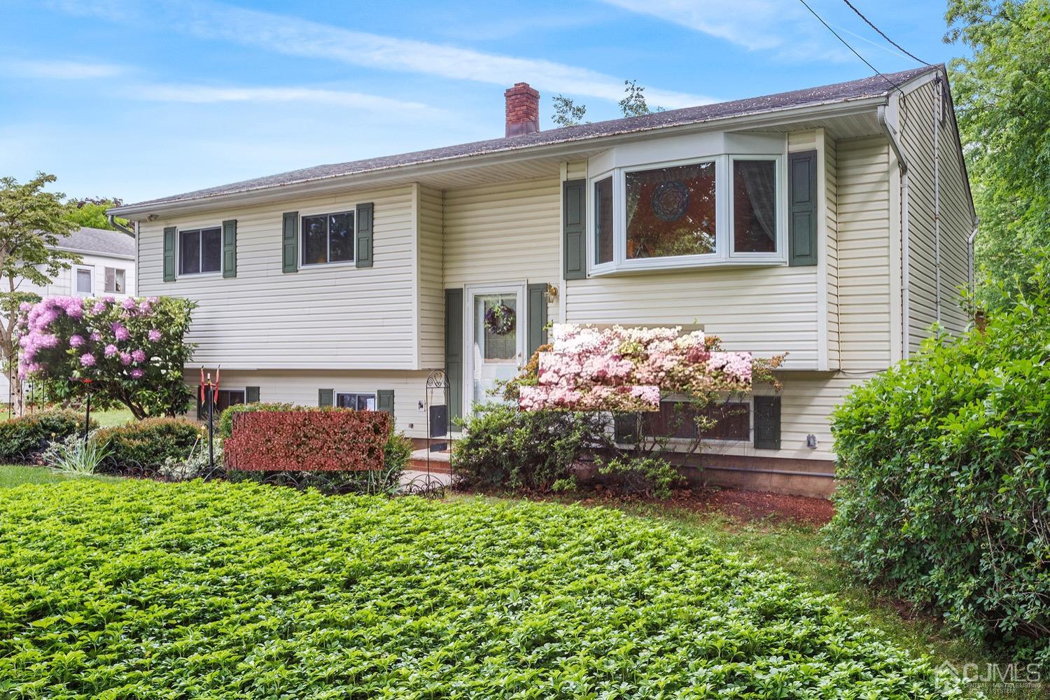 136 Lee Drive Middlesex, NJ 08846 - Photo 4 of 35 a front view of house with yard and flowers around