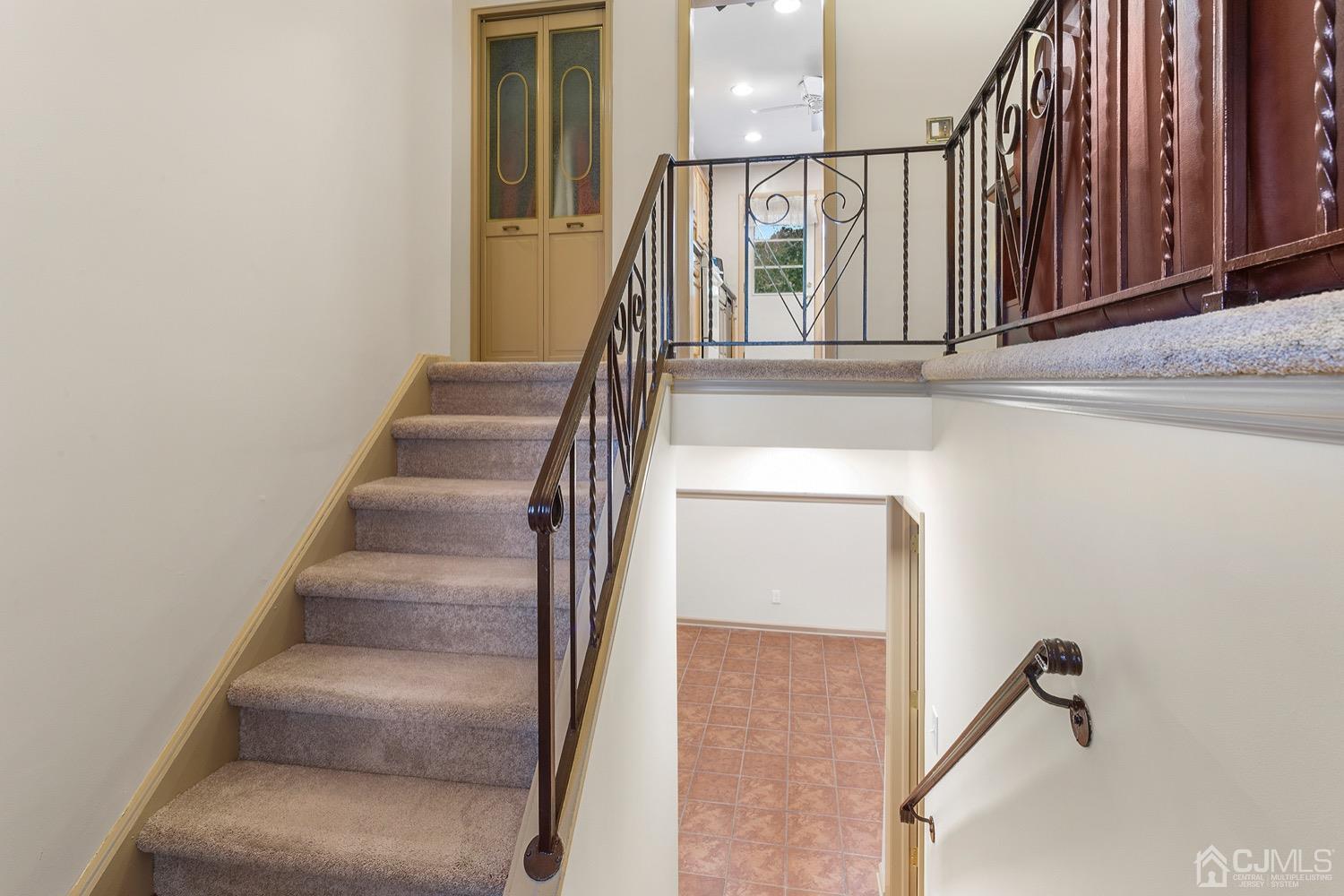 136 Lee Drive Middlesex, NJ 08846 - Photo 5 of 35 a view of staircase with lots of frames on wall and windows