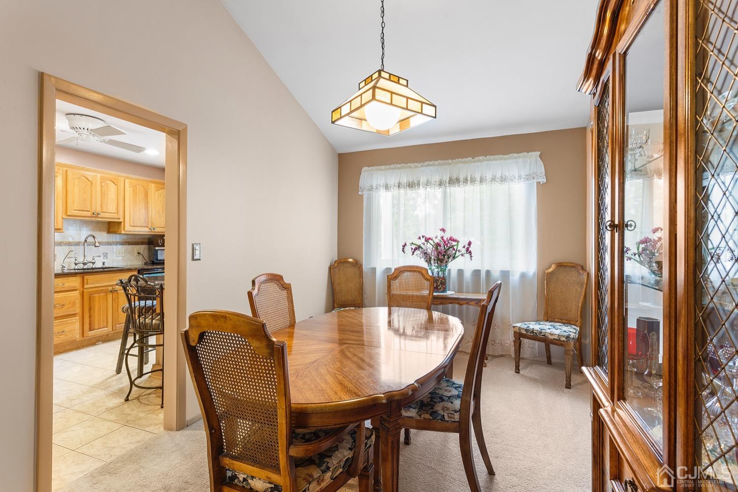 136 Lee Drive Middlesex, NJ 08846 - Photo 9 of 35 a dining room with furniture a window and a chandelier