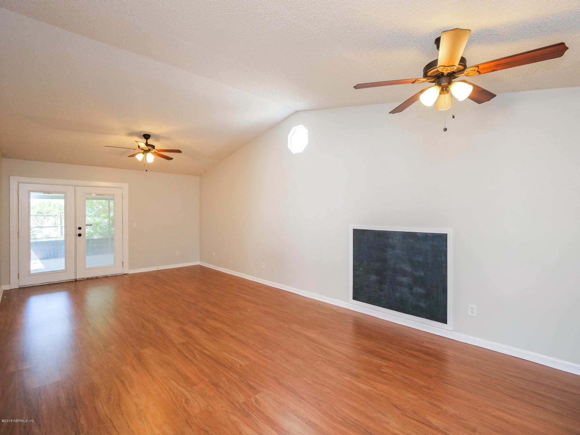 2448 Spring Vale Road Jacksonville, FL 32246 - Photo 6 of 24 a view of empty room with wooden floor and fan