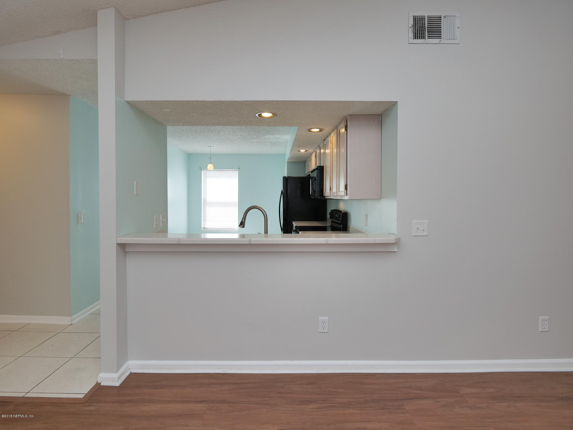 2448 Spring Vale Road Jacksonville, FL 32246 - Photo 8 of 24 a view of a hallway with wooden floor