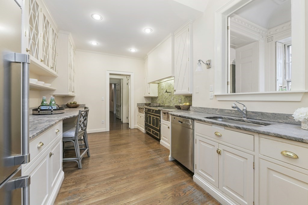 31 Chestnut Street Boston, MA 02108 - Photo 18 of 29 a large kitchen with granite countertop a large counter top stainless steel appliances and cabinets