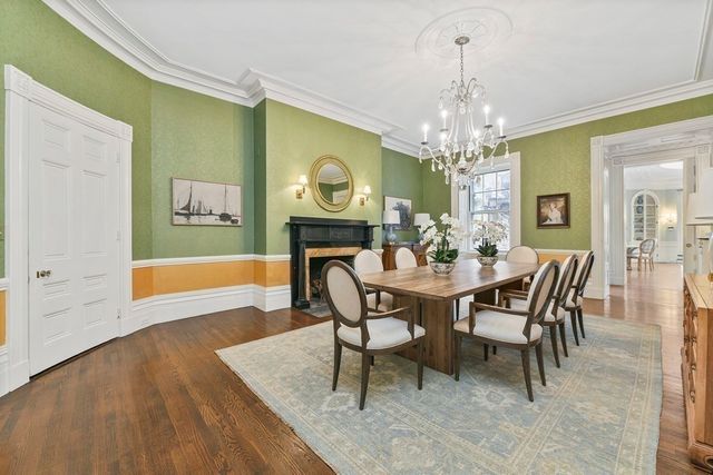 a living room with furniture a fireplace and a wooden floor