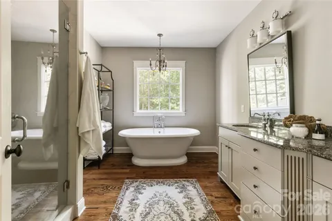 a spacious bathroom with a bathtub sink and toilet