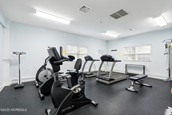 a kitchen with kitchen island a counter top space a sink stainless steel appliances and cabinets