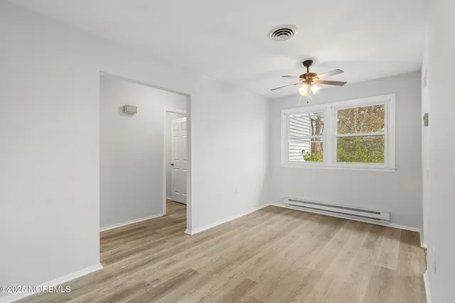 a kitchen with cabinets a sink stainless steel appliances and window