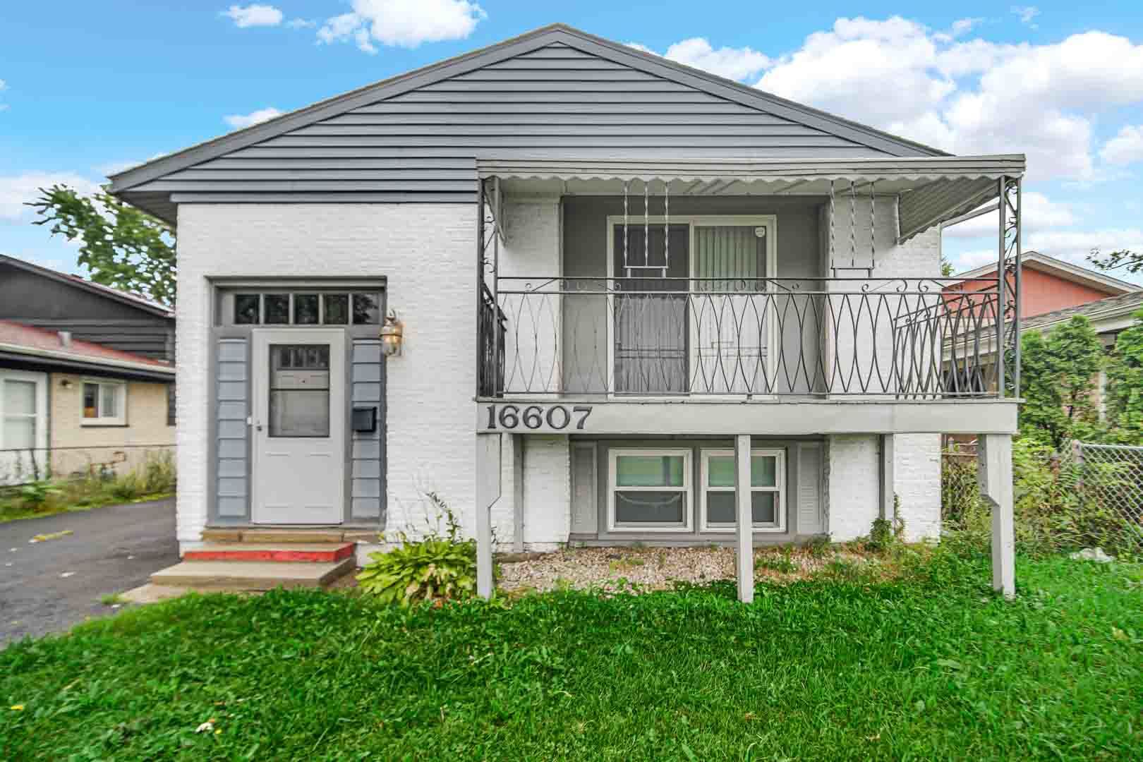 16607 Robey Street Markham, IL 60428 - Photo 1 of 24 front view of a house with a yard