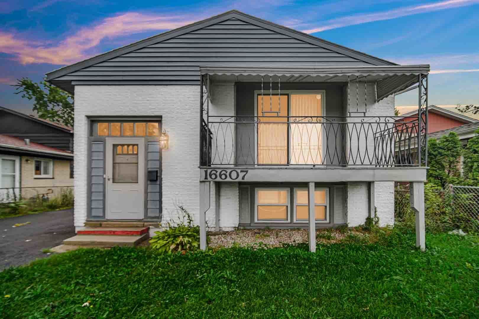 16607 Robey Street Markham, IL 60428 - Photo 2 of 24 a front view of a house with garden
