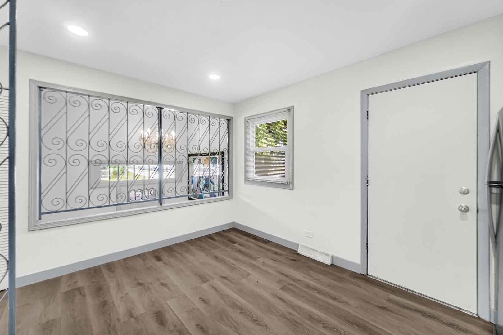 16607 Robey Street Markham, IL 60428 - Photo 21 of 24 an empty room with wooden floor and windows