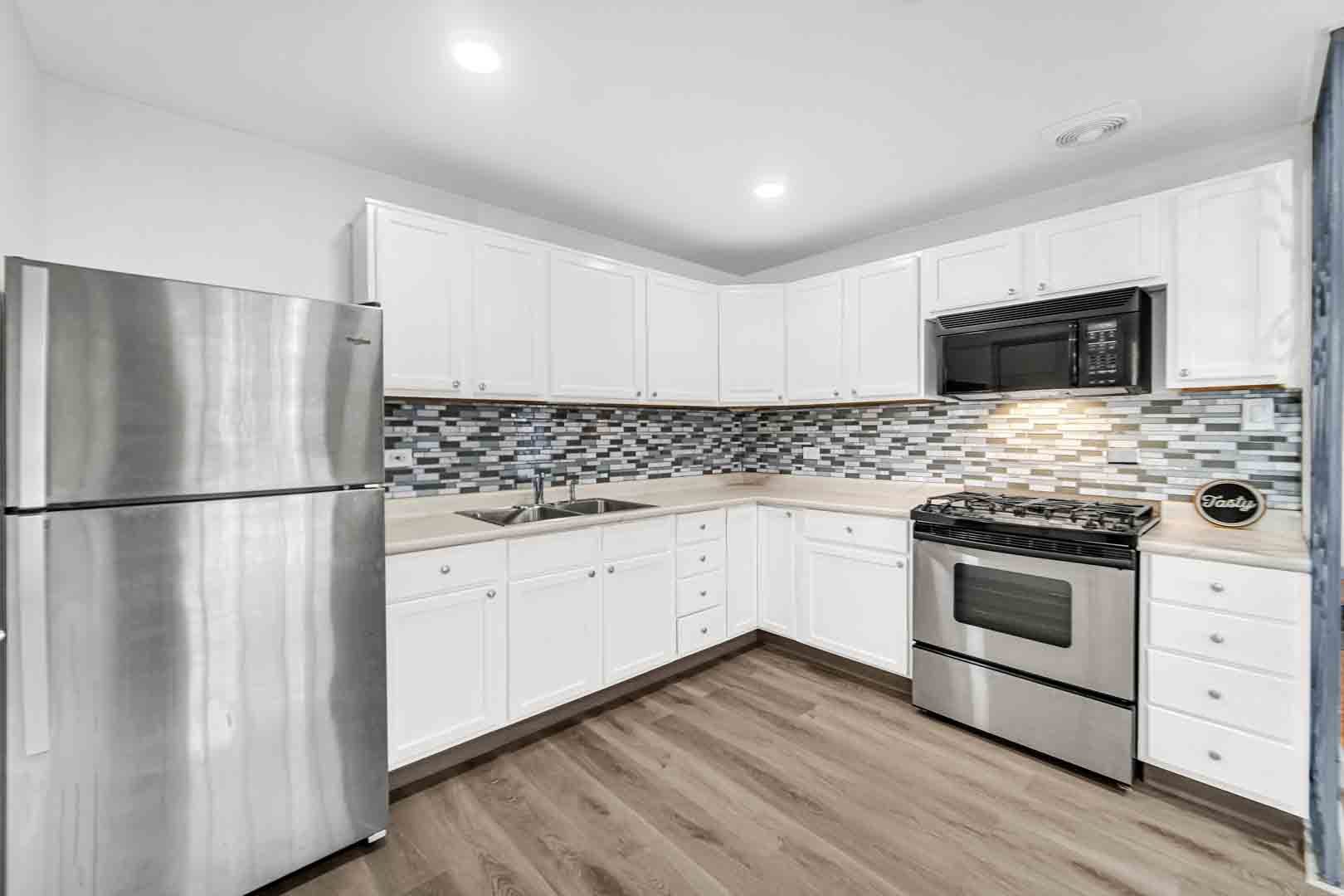 16607 Robey Street Markham, IL 60428 - Photo 22 of 24 a kitchen with granite countertop a refrigerator stove a sink dishwasher and a oven with wooden floor