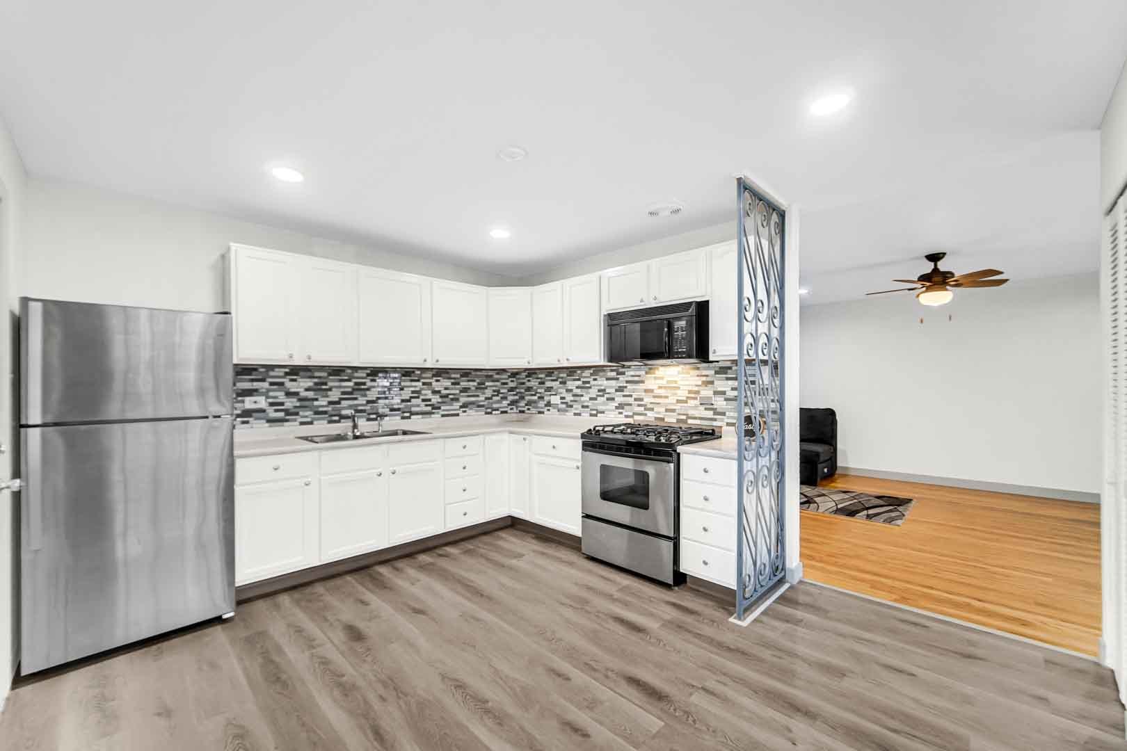 16607 Robey Street Markham, IL 60428 - Photo 23 of 24 a kitchen with a refrigerator stove and wooden floor