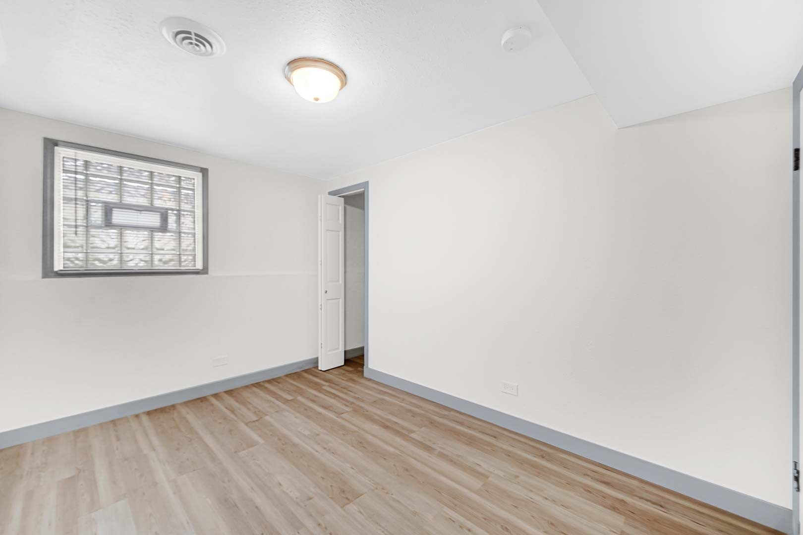 16607 Robey Street Markham, IL 60428 - Photo 7 of 24 a view of an empty room with wooden floor and a window