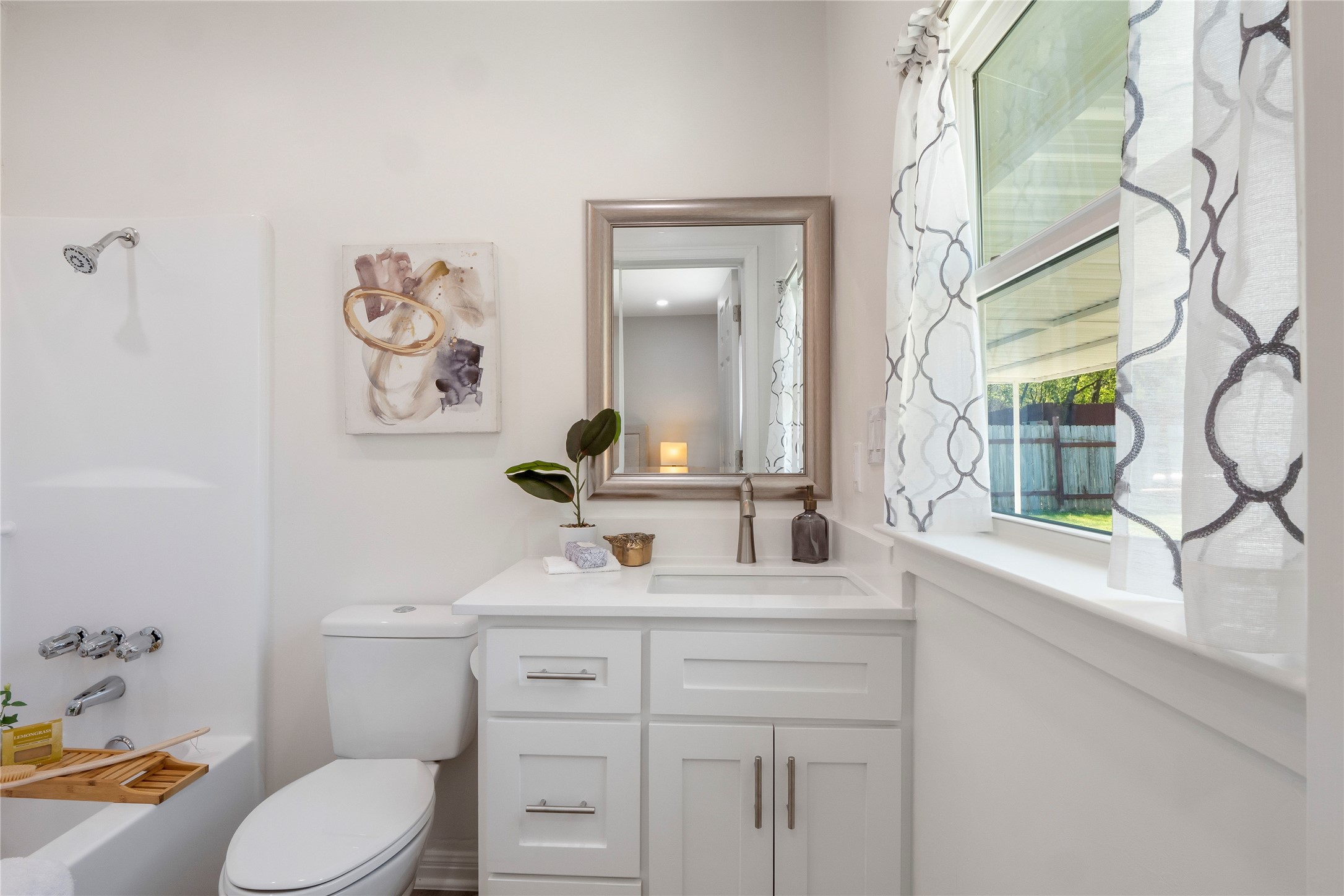 8007 Colony Loop Drive Austin, TX 78724 - Photo 21 of 40 Private en suite bath with quartz vanity, modern cabinetry, and natural light from the window.