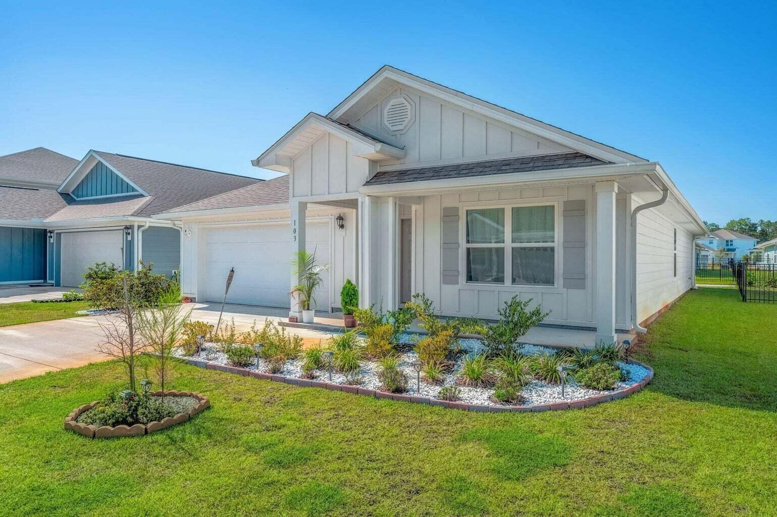 103 Riverwalk Circle Freeport, FL 32439 - Photo 1 of 34 a front view of a house with a yard