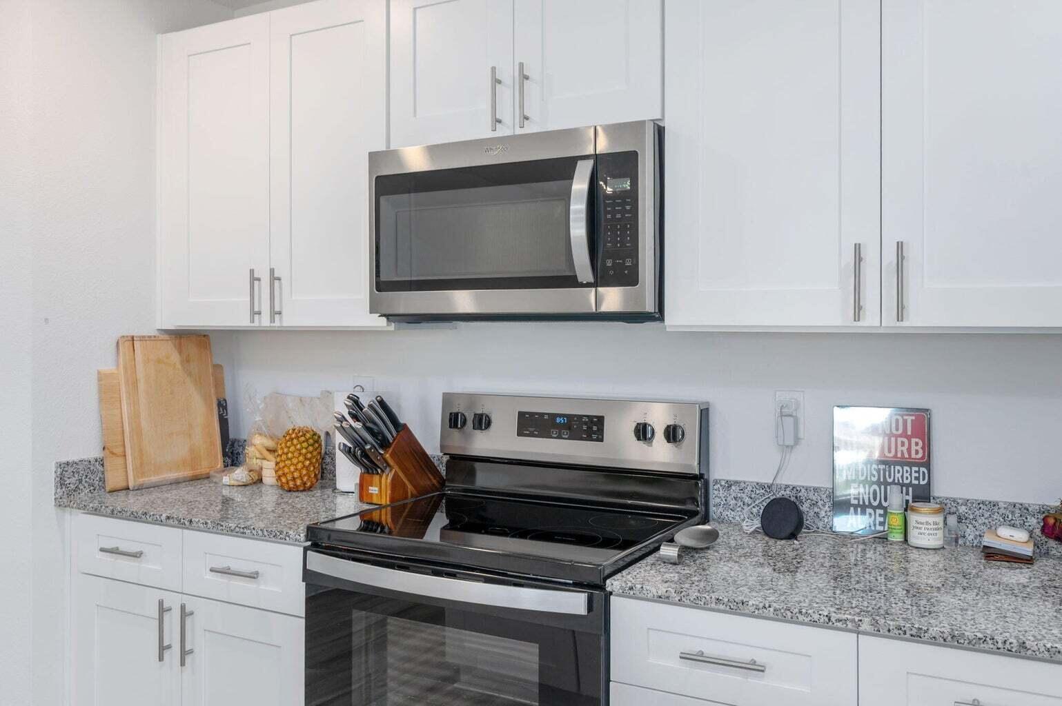 103 Riverwalk Circle Freeport, FL 32439 - Photo 16 of 34 a kitchen with granite countertop a stove and a microwave