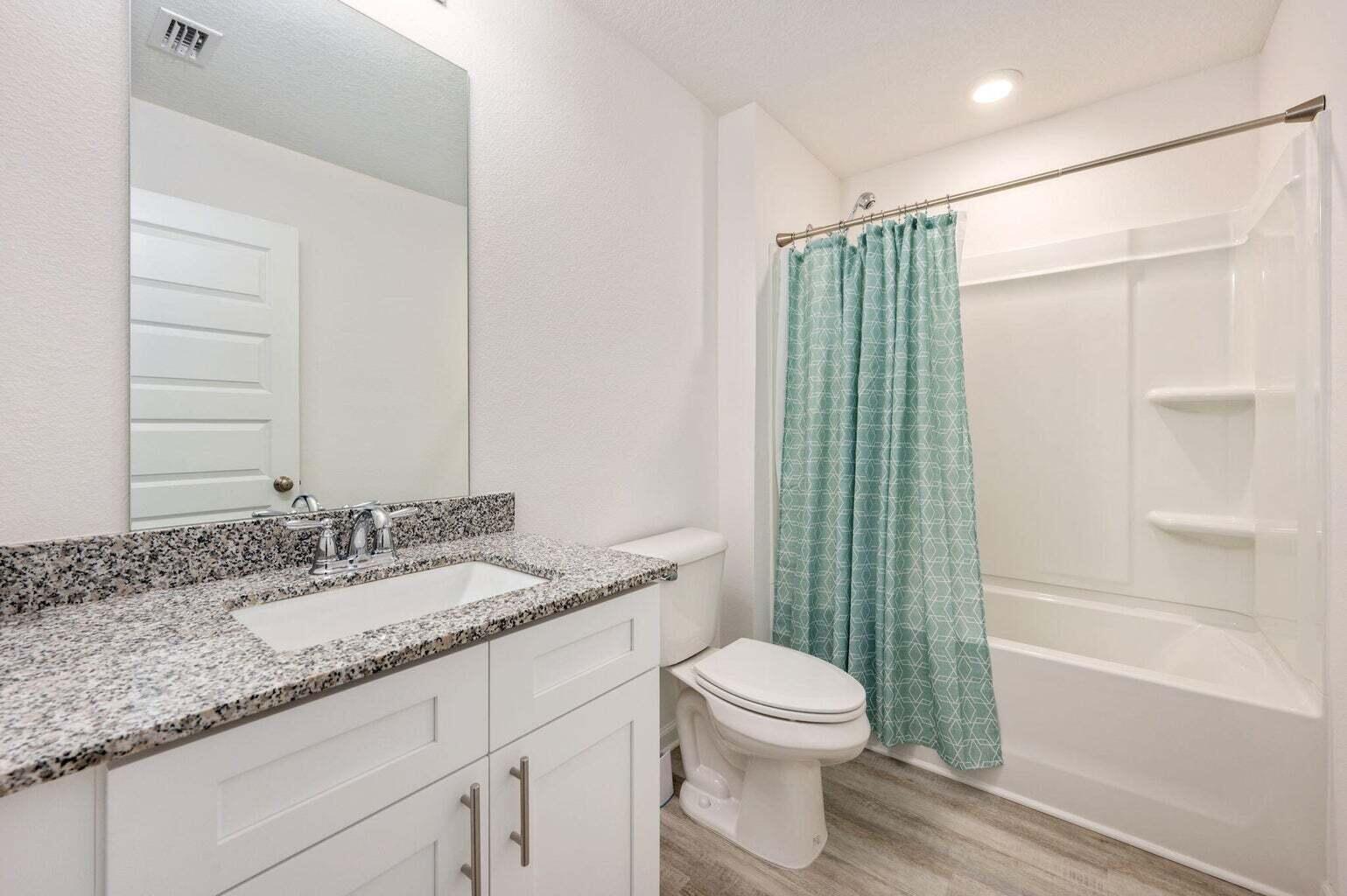 103 Riverwalk Circle Freeport, FL 32439 - Photo 25 of 34 a bathroom with a granite countertop sink toilet and shower