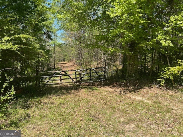 a view of a yard with wooden fence