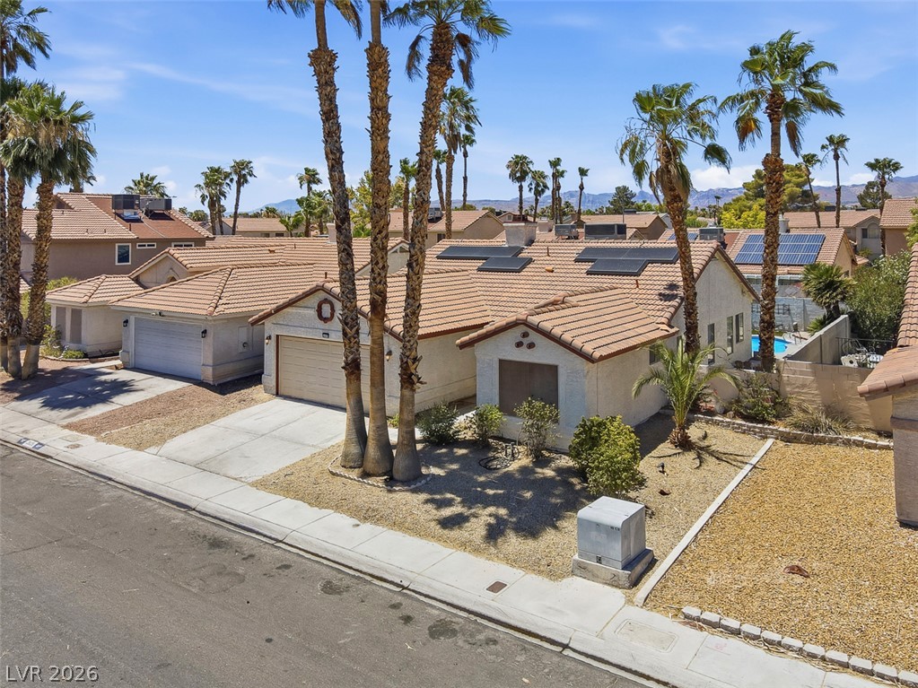 2609 Shakespeare Road Las Vegas, NV 89108 - Photo 36 of 41 A well-maintained street-facing dwelling with a concrete driveway and desert-friendly landscaping.