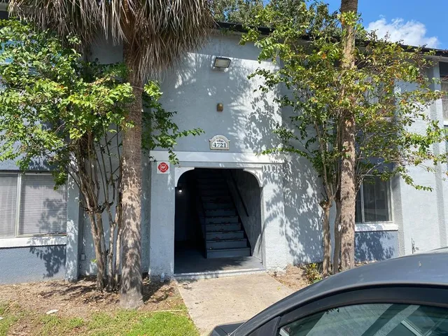a view of a house with a tree and a yard