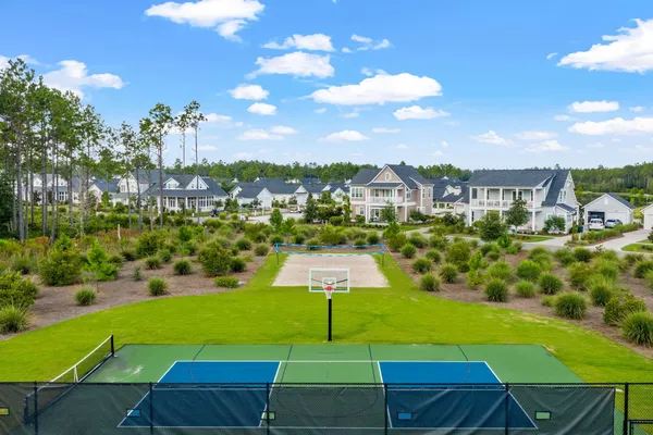 a view of a backyard with swimming pool and lawn chairs