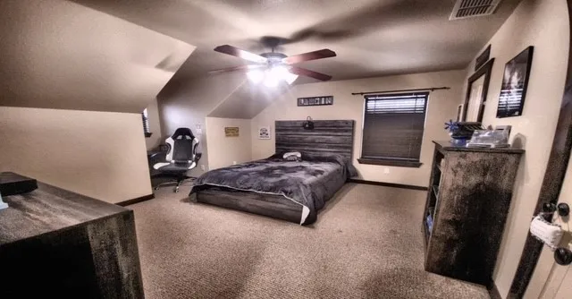 a spacious bedroom with a bed and a chandelier