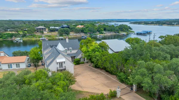 an aerial view of a house with a lake view