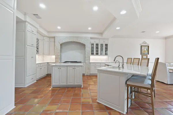 a kitchen with a stove a sink and a refrigerator