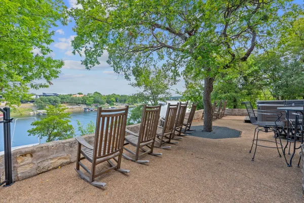a view of backyard with outdoor seating and trees