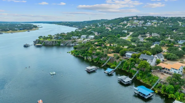 an aerial view of a houses with a lake view