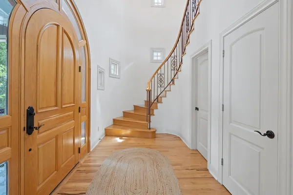 a view of a hallway with wooden floor and entryway