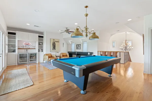 a room with lots of furniture and a chandelier