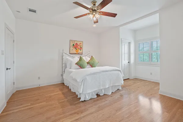 a bedroom with a bed and a chandelier