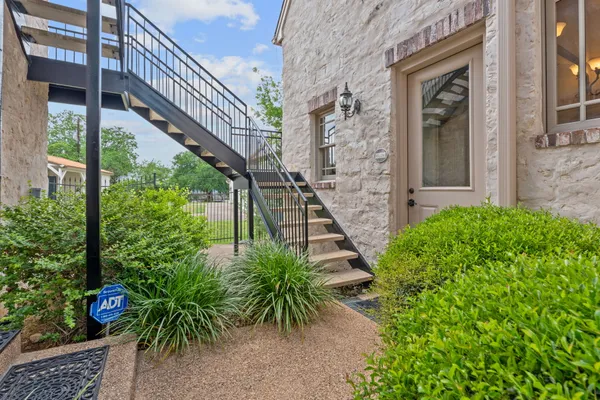 an entrance to ceiling windows with wooden floor
