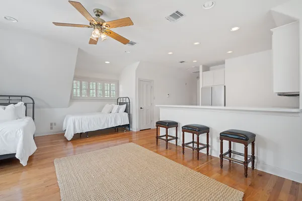 a bedroom with furniture and a large window