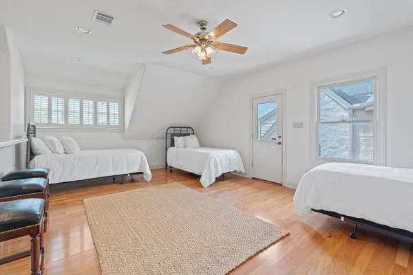 a spacious bedroom with two beds and a couch