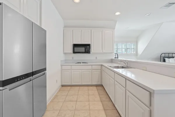 a kitchen with a sink window and cabinets